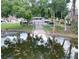 A tranquil pond is featured in this community, with a walkway to a gate and ample parking at 2557 Cedar Cypress Ct, Tampa, FL 33618