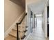 Hallway and carpeted staircase with neutral walls, black accents and views into the kitchen at 2557 Cedar Cypress Ct, Tampa, FL 33618
