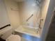 Bathroom features a tiled bathtub, shower, grab bar, and tiled floor, showing the shower area at 2621 Cove Cay Dr # 206, Clearwater, FL 33760
