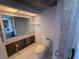 Unfinished bathroom featuring exposed pipes, toilet, mirror, and view into kitchen at 2621 Cove Cay Dr # 206, Clearwater, FL 33760