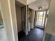 Hallway featuring water heater, AC, exposed beams, and exterior door to deck at the end at 2621 Cove Cay Dr # 206, Clearwater, FL 33760