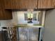 View from kitchen to living room with exposed beams and appliances in the kitchen at 2621 Cove Cay Dr # 206, Clearwater, FL 33760