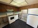 Partially demolished kitchen with appliances and a window through to the living room at 2621 Cove Cay Dr # 206, Clearwater, FL 33760