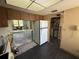 View of kitchen with appliances, partially exposed walls, and view to living room at 2621 Cove Cay Dr # 206, Clearwater, FL 33760