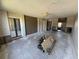 Spacious living room shows exposed concrete, and has a ceiling fan and sliding doors to the outside at 2621 Cove Cay Dr # 206, Clearwater, FL 33760
