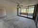 Spacious living room has sliding glass doors with views, exposed concrete, and opens to other parts of the home at 2621 Cove Cay Dr # 206, Clearwater, FL 33760