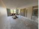 A bright living room features exposed concrete, a ceiling fan, and open access to other parts of the home at 2621 Cove Cay Dr # 206, Clearwater, FL 33760