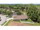 Aerial view of a well-maintained single-Gathering home with a green lawn and white fence at 26749 Middleground Loop, Wesley Chapel, FL 33544