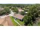 An aerial shot showcases the home's manicured lawn, fenced backyard, and proximity to lush greenery at 26749 Middleground Loop, Wesley Chapel, FL 33544
