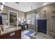 Walk-in shower with glass door and decorative tile floor at 26749 Middleground Loop, Wesley Chapel, FL 33544
