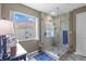 The walk-in shower features a glass door and a decorative tile floor at 26749 Middleground Loop, Wesley Chapel, FL 33544