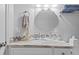 Elegant bathroom featuring a vanity with marble countertop and decorative light fixture at 26749 Middleground Loop, Wesley Chapel, FL 33544