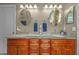 Bathroom features dual sinks, granite countertops, and stylish fixtures with a decorative tile floor at 26749 Middleground Loop, Wesley Chapel, FL 33544