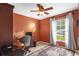 Cozy bedroom with a large window, neutral walls, and ample natural light at 26749 Middleground Loop, Wesley Chapel, FL 33544