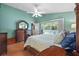 This spacious bedroom features wood floors and a double door to a private outdoor space at 26749 Middleground Loop, Wesley Chapel, FL 33544