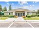 Welcoming community center is enhanced by white pillars, manicured landscaping, and ample parking for residents and guests at 26749 Middleground Loop, Wesley Chapel, FL 33544
