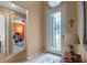 Foyer features a decorative glass door, leading to a bright interior at 26749 Middleground Loop, Wesley Chapel, FL 33544