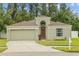 Charming single-story home with a two-car garage and well-manicured lawn at 26749 Middleground Loop, Wesley Chapel, FL 33544