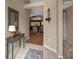 Inviting foyer with tiled flooring, table and view of living area at 26749 Middleground Loop, Wesley Chapel, FL 33544
