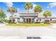 The Lexington Oaks Golf Club building is surrounded by lush landscaping and American flags, creating a welcoming atmosphere at 26749 Middleground Loop, Wesley Chapel, FL 33544