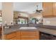 Well-lit kitchen with a sink overlooking the living room and backyard, and a dishwasher at 26749 Middleground Loop, Wesley Chapel, FL 33544