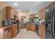 Updated kitchen featuring tile floors, wood cabinets, modern appliances, and an open layout at 26749 Middleground Loop, Wesley Chapel, FL 33544