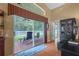 This living room features a wall of glass that leads to an outdoor patio at 26749 Middleground Loop, Wesley Chapel, FL 33544