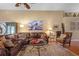 Comfortable living room featuring a plush leather sectional, a patterned rug, and stylish decor at 26749 Middleground Loop, Wesley Chapel, FL 33544