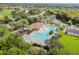 Aerial view of the community pool and playground surrounded by well-maintained landscaping and greenery at 26749 Middleground Loop, Wesley Chapel, FL 33544