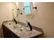 Bathroom features dual glass vessel sinks, granite counters and updated fixtures at 2841 S Cranberry Blvd, North Port, FL 34286