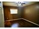 Cozy bedroom with wood laminate flooring, ceiling fan, and natural lighting at 2841 S Cranberry Blvd, North Port, FL 34286