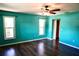 Bright bedroom with dark hardwood floors, ceiling fan and natural light from two windows at 2841 S Cranberry Blvd, North Port, FL 34286