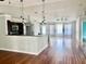 Bright, open-concept living room with hardwood flooring and modern lighting fixtures at 2841 S Cranberry Blvd, North Port, FL 34286