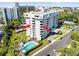 Aerial view of condominium complex with pool, covered parking, and balcony views at 30 Turner St # 704, Clearwater, FL 33756