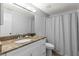Bathroom with updated vanity, granite countertop, and shower with curtain at 30 Turner St # 704, Clearwater, FL 33756