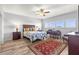 Cozy bedroom features a ceiling fan, stylish rug, and light-filled windows at 30 Turner St # 704, Clearwater, FL 33756