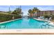 Inviting community swimming pool with lounge chairs and palm trees at 30 Turner St # 704, Clearwater, FL 33756