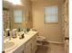 Bathroom featuring dual sinks, vanity, and a large mirror at 3200 Sandy Ridge Dr, Clearwater, FL 33761