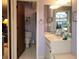 Bathroom with a vanity and mirror and toilet in the background with decorative accessories at 3200 Sandy Ridge Dr, Clearwater, FL 33761