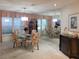 Formal dining room with glass table, mirrored wall, carpet, and chandelier at 3200 Sandy Ridge Dr, Clearwater, FL 33761