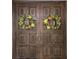 Wooden double front door adorned with decorative wreaths, enhancing the home's welcoming appeal at 3200 Sandy Ridge Dr, Clearwater, FL 33761