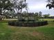 Well maintained community grounds with mature trees and manicured shrubs on an overcast day at 3200 Sandy Ridge Dr, Clearwater, FL 33761