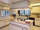 Spacious kitchen with a large island, light cabinets, and a window overlooking the backyard at 3200 Sandy Ridge Dr, Clearwater, FL 33761