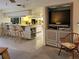 Open kitchen with a breakfast bar and pass-through to an adjacent living area with TV at 3200 Sandy Ridge Dr, Clearwater, FL 33761