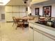 Bright kitchen with an island with countertop cooktop and dining area with a wooden table and chairs at 3200 Sandy Ridge Dr, Clearwater, FL 33761