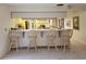 Open-concept kitchen with a breakfast bar featuring four stools and a serving area at 3200 Sandy Ridge Dr, Clearwater, FL 33761