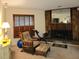 Cozy living room features a stone fireplace, wood-trimmed windows, and comfortable seating at 3200 Sandy Ridge Dr, Clearwater, FL 33761