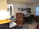 Home office with large desk, leather chairs, and plenty of natural light at 3200 Sandy Ridge Dr, Clearwater, FL 33761