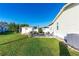 Spacious backyard featuring a patio with outdoor seating, a storage shed, and lush green grass at 37338 Sandra Ave, Zephyrhills, FL 33542