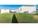 Expansive backyard showcasing a patio with a grill and outdoor seating next to a storage shed at 37338 Sandra Ave, Zephyrhills, FL 33542